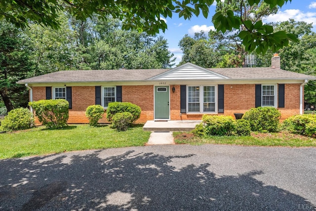 1853 Rainbow Forest Dr, Lynchburg, VA 24502 - ranch-style home featuring brick siding, a chimney, a front lawn, and a shingled roof