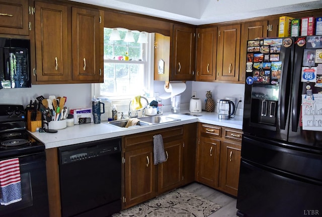 1769 Izaak Walton Rd, Madison Heights, VA 24572 - kitchen with black appliances, light countertops, and light wood-style flooring