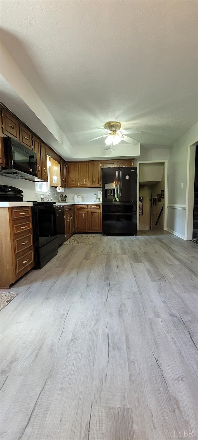 1769 Izaak Walton Rd, Madison Heights, VA 24572 - kitchen with black appliances, light wood-style flooring, light countertops, and a ceiling fan