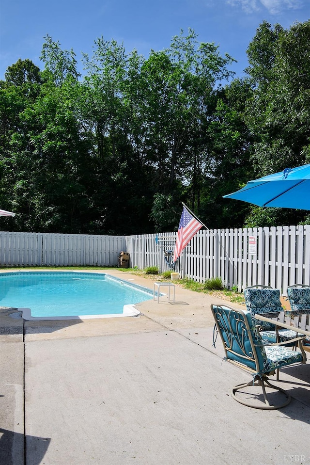 1769 Izaak Walton Rd, Madison Heights, VA 24572 - view of swimming pool with a patio area, a fenced backyard, and view of wooded area