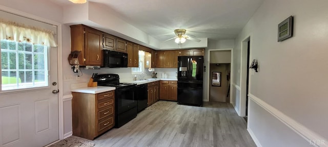 1769 Izaak Walton Rd, Madison Heights, VA 24572 - kitchen with black appliances, light countertops, ceiling fan, and light wood-style floors