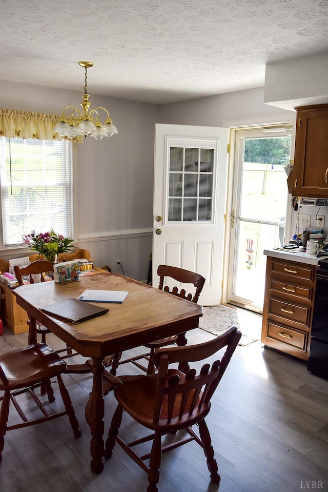 1769 Izaak Walton Rd, Madison Heights, VA 24572 - dining room with dark wood-style flooring, a textured ceiling, and a chandelier
