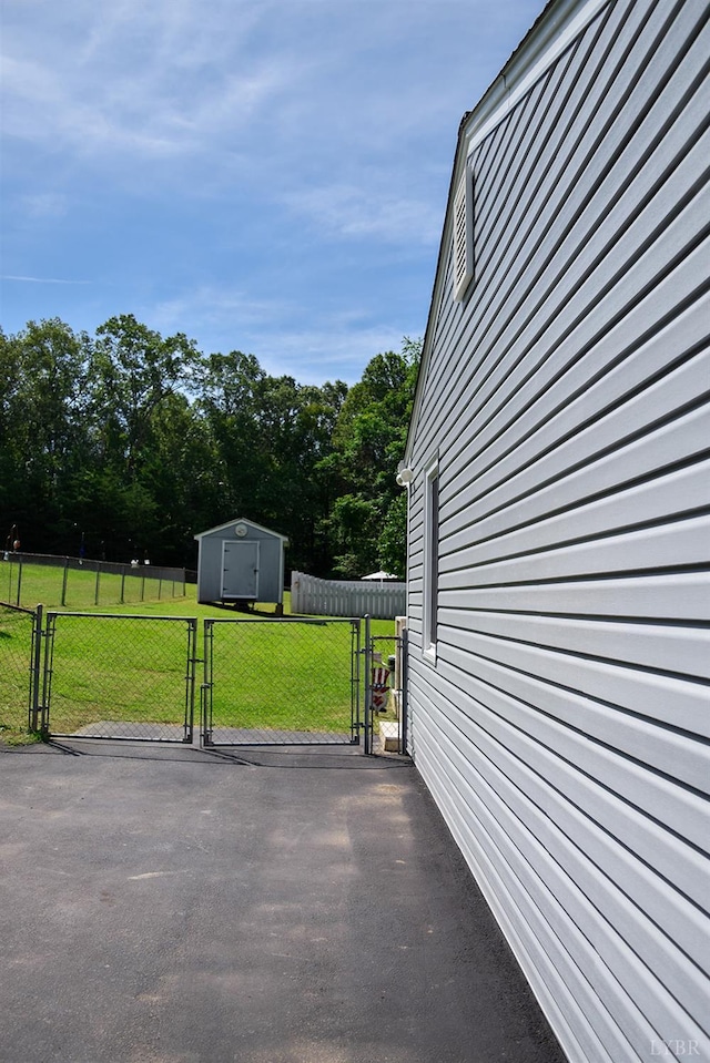 1769 Izaak Walton Rd, Madison Heights, VA 24572 - view of patio featuring a gate and a storage unit