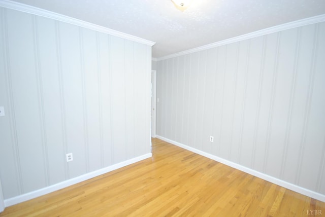 6120 Edgewood Ave, Lynchburg, VA 24502 - spare room featuring light wood-style flooring, crown molding, a decorative wall, and a textured ceiling