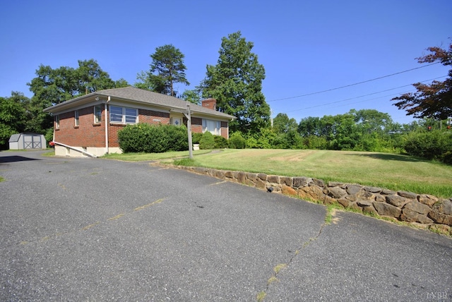6120 Edgewood Ave, Lynchburg, VA 24502 - view of property exterior with brick siding, a storage unit, a chimney, and a yard