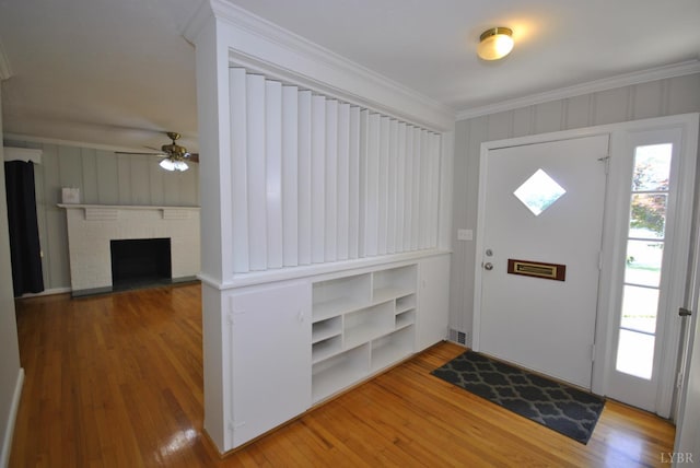 6120 Edgewood Ave, Lynchburg, VA 24502 - foyer entrance with a ceiling fan, light wood finished floors, ornamental molding, and a fireplace