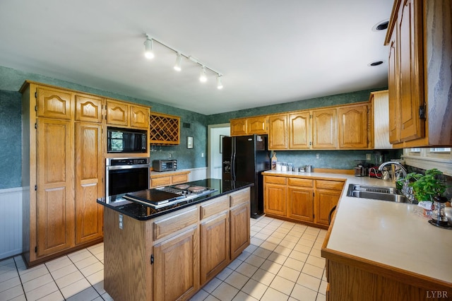 2833 Link Rd, Lynchburg, VA 24503 - kitchen featuring black appliances, light tile patterned flooring, a center island, rail lighting, and a wainscoted wall