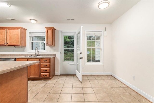 3600 Old Forest Rd Unit 107, Lynchburg, VA 24501 - kitchen with light countertops, light tile patterned flooring, and brown cabinets