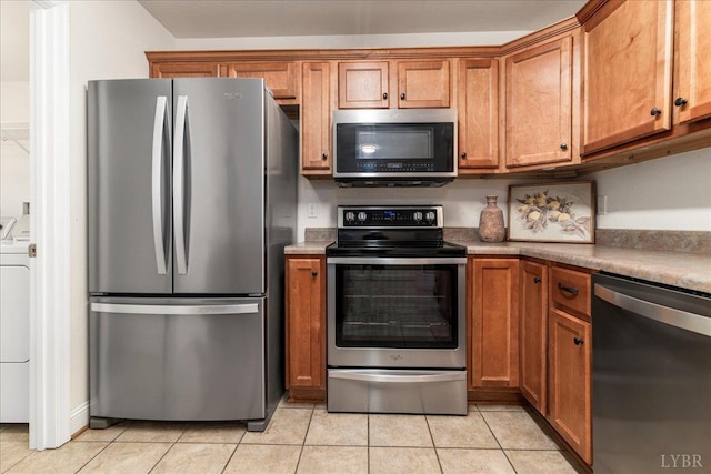 3600 Old Forest Rd Unit 107, Lynchburg, VA 24501 - kitchen featuring appliances with stainless steel finishes, brown cabinetry, and light tile patterned floors