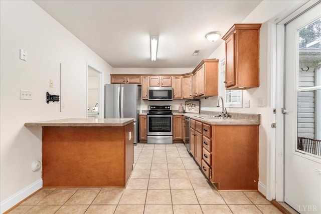 3600 Old Forest Rd Unit 107, Lynchburg, VA 24501 - kitchen featuring stainless steel appliances, brown cabinets, light tile patterned floors, a peninsula, and light countertops