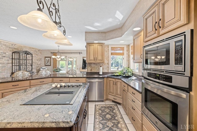 112 Haines Point Ter, Forest, VA 24551 - kitchen with appliances with stainless steel finishes, a chandelier, light tile patterned floors, dark stone counters, and a kitchen island