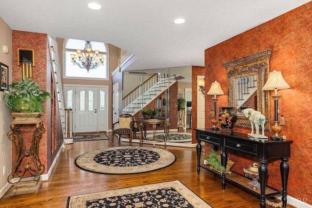 112 Haines Point Ter, Forest, VA 24551 - foyer with stairway, wallpapered walls, wood finished floors, a chandelier, and a textured ceiling