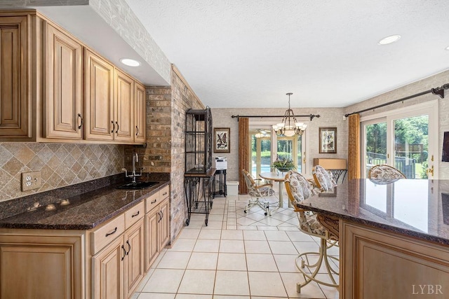 112 Haines Point Ter, Forest, VA 24551 - kitchen featuring a chandelier, light tile patterned flooring, decorative light fixtures, dark stone countertops, and decorative backsplash