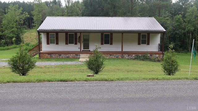 863 Winfall Rd, Gladys, VA 24554 - view of front of house featuring a metal roof, covered porch, a front lawn, and a forest view