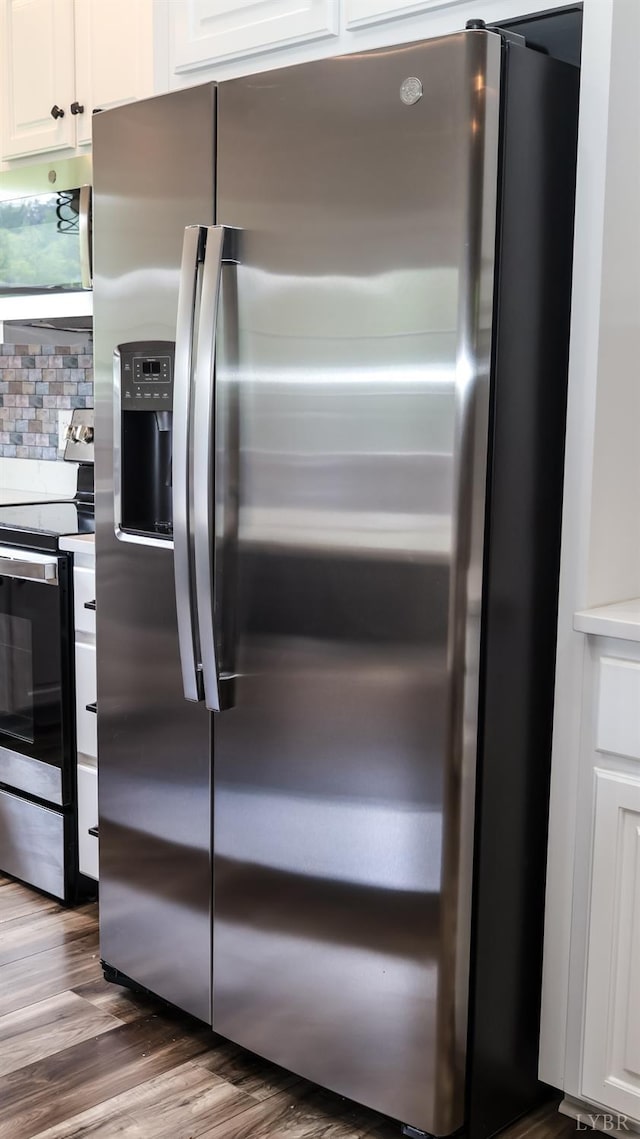 863 Winfall Rd, Gladys, VA 24554 - kitchen with appliances with stainless steel finishes, wood finished floors, white cabinetry, and backsplash