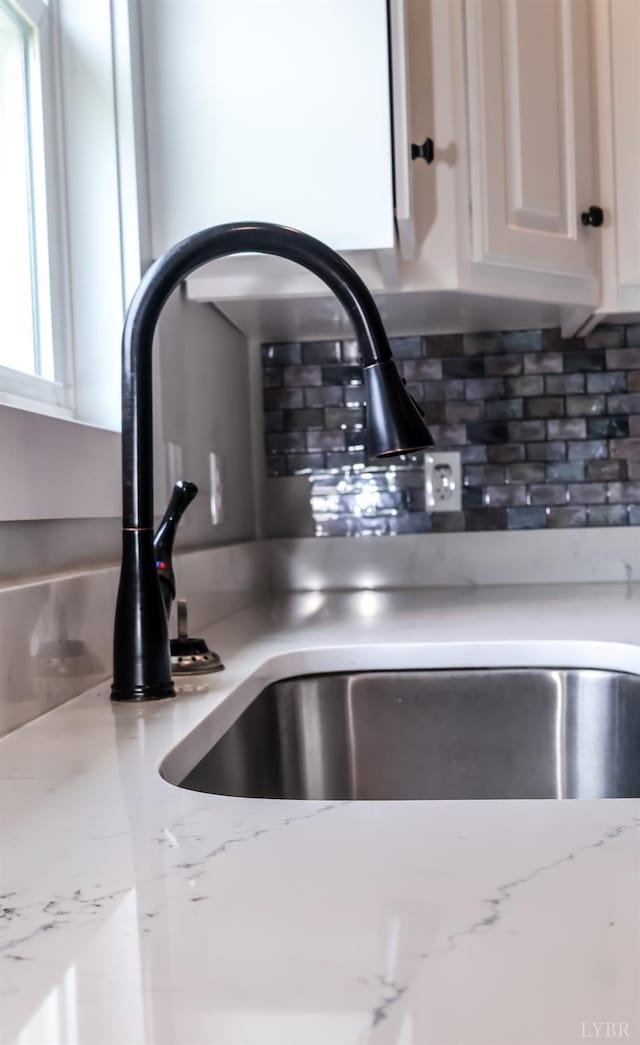 863 Winfall Rd, Gladys, VA 24554 - kitchen view of decorative backsplash, light stone counters, and white cabinetry