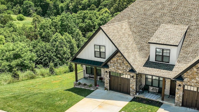1659 Helmsdale Dr, Forest, VA 24551 - view of front of property featuring board and batten siding, stone siding, a porch, a garage, and roof with shingles