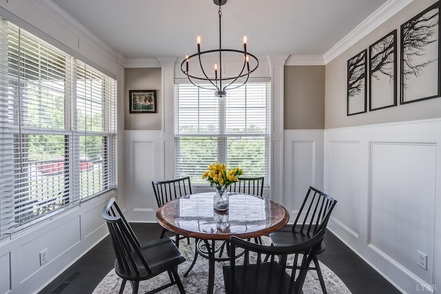1659 Helmsdale Dr, Forest, VA 24551 - dining room with a decorative wall, a chandelier, crown molding, healthy amount of natural light, and dark wood-style floors