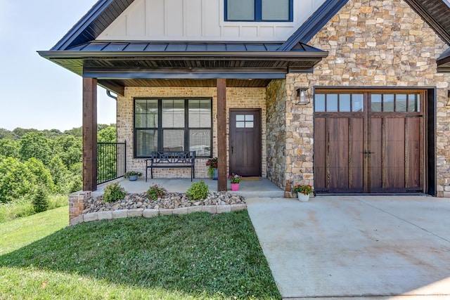 1659 Helmsdale Dr, Forest, VA 24551 - property entrance with covered porch, board and batten siding, a garage, concrete driveway, and stone siding