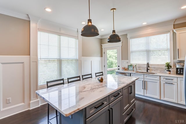 1659 Helmsdale Dr, Forest, VA 24551 - kitchen with a decorative wall, a breakfast bar, ornamental molding, a wainscoted wall, and dark wood-style floors