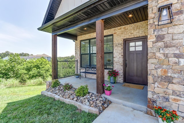 1659 Helmsdale Dr, Forest, VA 24551 - view of exterior entry featuring a porch, stone siding, board and batten siding, and a lawn