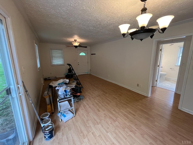 115 Primrose Ln, Lynchburg, VA 24501 - unfurnished living room with a chandelier, a textured ceiling, light wood-type flooring, ornamental molding, and ceiling fan