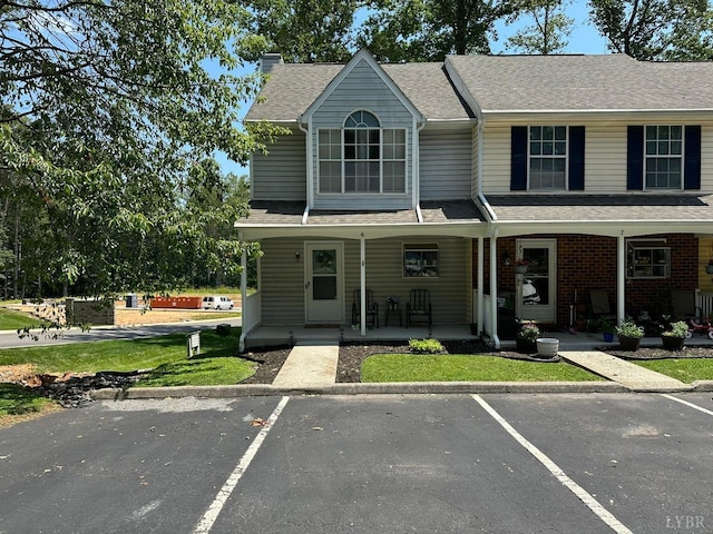 6 Jefferson Village Dr, Forest, VA 24551 - townhome / multi-family property featuring uncovered parking, covered porch, a shingled roof, and brick siding