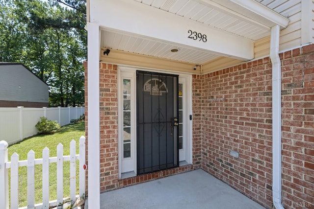 2398 Azalea Garden Rd, Norfolk, VA 23513 - doorway to property featuring brick siding and a security system