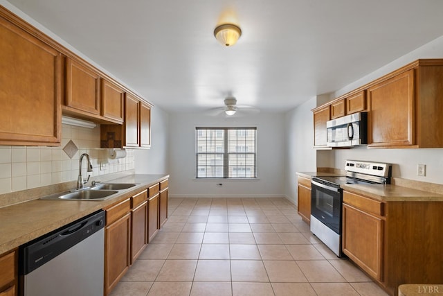 2398 Azalea Garden Rd, Norfolk, VA 23513 - kitchen with stainless steel appliances, ceiling fan, brown cabinets, backsplash, and light tile patterned floors
