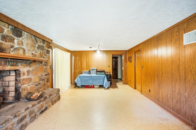 723 Custer Dr, Lynchburg, VA 24502 - bedroom featuring wood walls, a fireplace, ornamental molding, and a textured ceiling