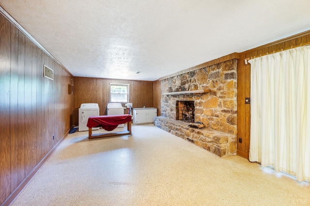 723 Custer Dr, Lynchburg, VA 24502 - bedroom with separate washer and dryer, wooden walls, a textured ceiling, and a stone fireplace