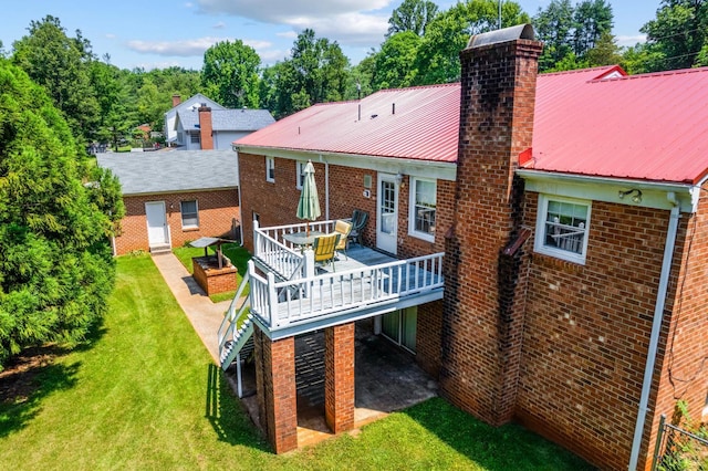 723 Custer Dr, Lynchburg, VA 24502 - rear view of house featuring a chimney, a lawn, a deck, brick siding, and a metal roof
