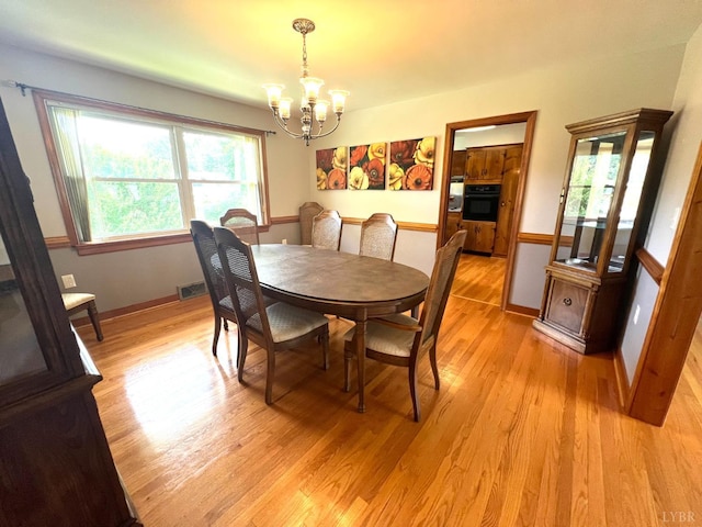 149 Powtan Dr, Lynchburg, VA 24502 - dining area featuring a chandelier, light wood-style floors, and healthy amount of natural light