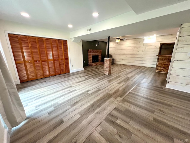 149 Powtan Dr, Lynchburg, VA 24502 - unfurnished living room with wood finished floors, a fireplace, wooden walls, and recessed lighting