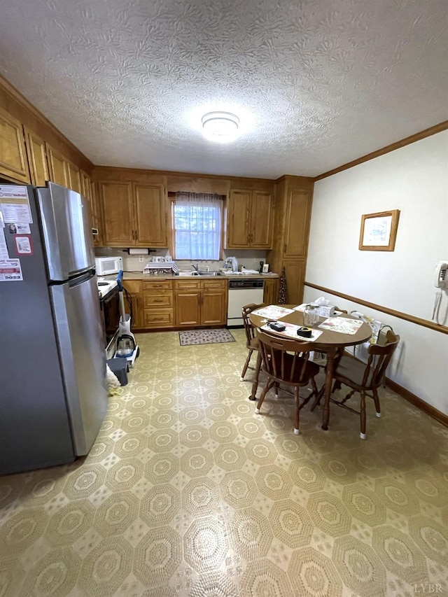 1102 Smith St, Bedford, VA 24523 - kitchen with white appliances, brown cabinetry, a textured ceiling, light flooring, and crown molding