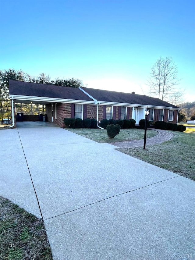 1102 Smith St, Bedford, VA 24523 - ranch-style home featuring concrete driveway, an attached carport, a front yard, and brick siding