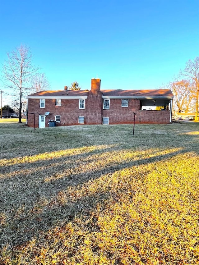 1102 Smith St, Bedford, VA 24523 - rear view of property with a lawn, a chimney, and brick siding