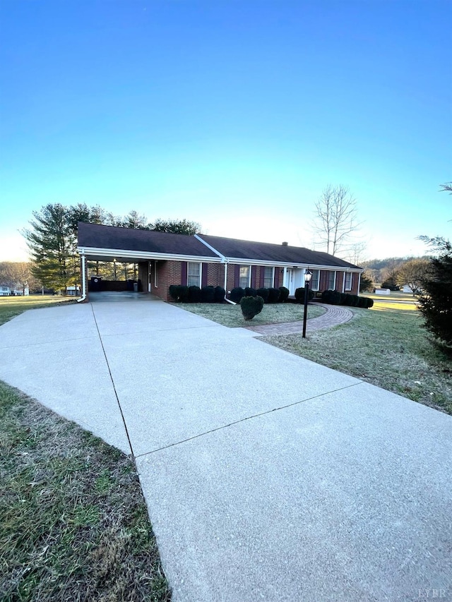 1102 Smith St, Bedford, VA 24523 - ranch-style house with driveway, a front yard, a carport, and brick siding