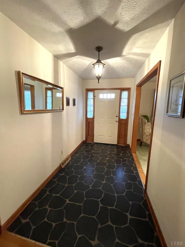 1102 Smith St, Bedford, VA 24523 - entryway with dark stone finish floors and a textured ceiling