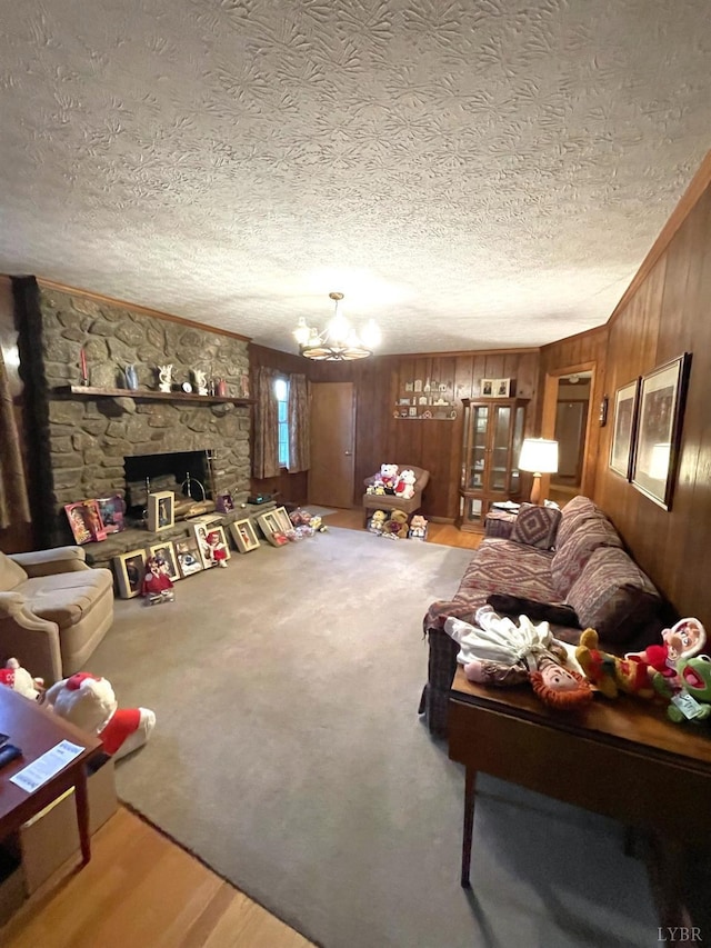 1102 Smith St, Bedford, VA 24523 - living area featuring a textured ceiling, wood finished floors, wood walls, a chandelier, and ornamental molding