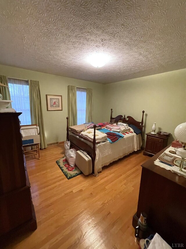 1102 Smith St, Bedford, VA 24523 - bedroom with a textured ceiling, wood finished floors, and multiple windows