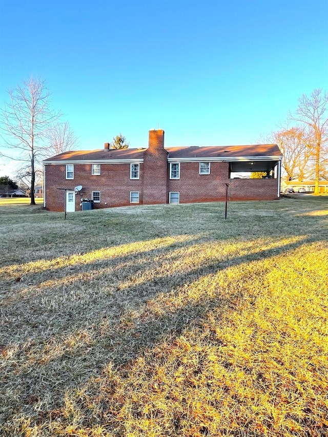 1102 Smith St, Bedford, VA 24523 - rear view of property featuring a lawn, brick siding, and a chimney