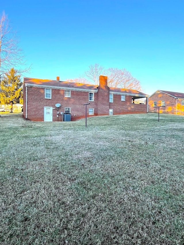 1102 Smith St, Bedford, VA 24523 - rear view of property featuring brick siding, a chimney, and a lawn