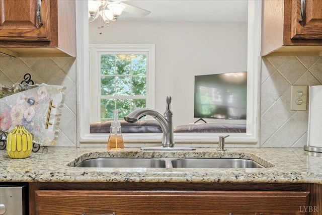 702 Kings Rd, Lynchburg, VA 24502 - kitchen with brown cabinetry, decorative backsplash, light stone countertops, and ceiling fan