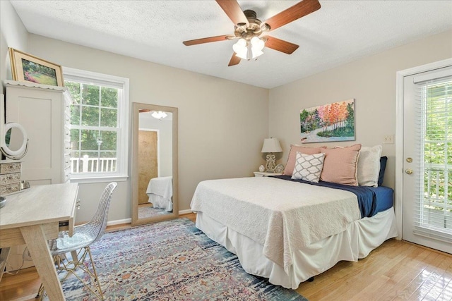 702 Kings Rd, Lynchburg, VA 24502 - bedroom featuring light wood finished floors, multiple windows, access to exterior, a textured ceiling, and ceiling fan