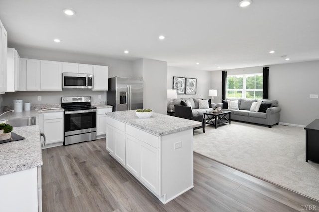 50 Levi Ln, Lynchburg, VA 24502 - kitchen featuring appliances with stainless steel finishes, a center island, recessed lighting, white cabinetry, and wood finished floors