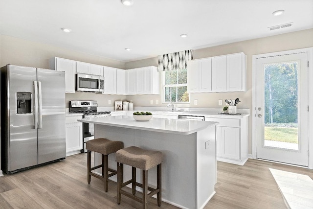 50 Levi Ln, Lynchburg, VA 24502 - kitchen with appliances with stainless steel finishes, a kitchen breakfast bar, white cabinetry, light countertops, and recessed lighting