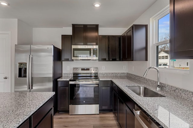 45 Levi Ln, Lynchburg, VA 24502 - kitchen with appliances with stainless steel finishes, recessed lighting, light stone countertops, light wood-style flooring, and dark brown cabinetry