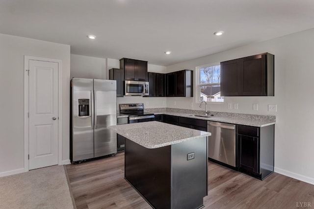 45 Levi Ln, Lynchburg, VA 24502 - kitchen featuring stainless steel appliances, a center island, light stone countertops, light wood-style floors, and recessed lighting