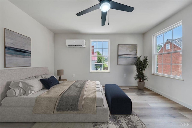 614 7th St, Lynchburg, VA 24504 - bedroom with a wall mounted AC, multiple windows, wood finished floors, and a ceiling fan